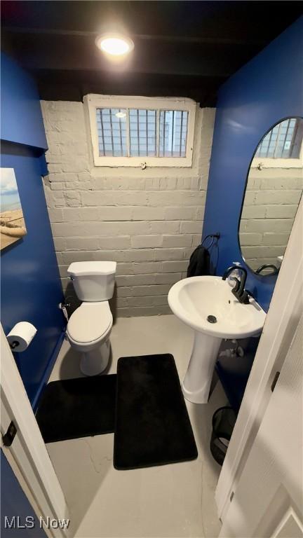 half bathroom featuring toilet and a sink