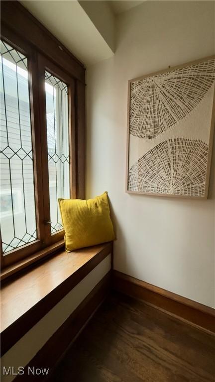 sitting room featuring baseboards and wood finished floors