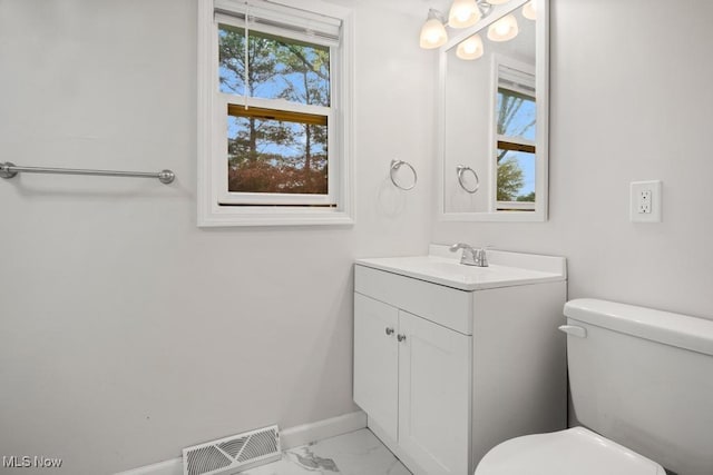 5331 Ridgewood St, Lorain, OH 44055 - bathroom featuring baseboards, marble finish floor, toilet, visible vents, and vanity