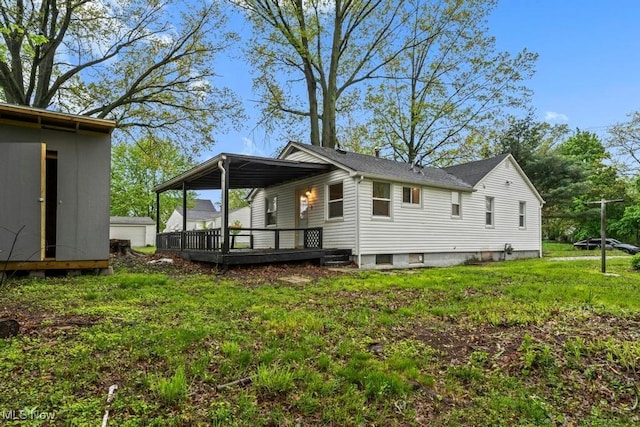 5331 Ridgewood St, Lorain, OH 44055 - rear view of property with a storage shed, a yard, an outdoor structure, and a deck