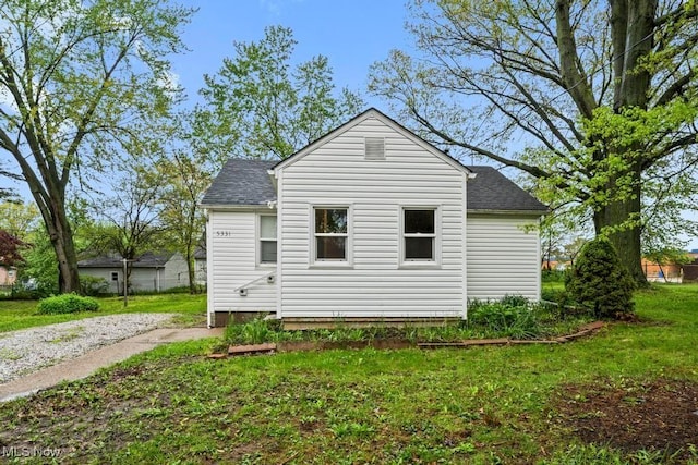 5331 Ridgewood St, Lorain, OH 44055 - back of property with a yard and roof with shingles