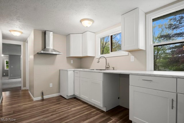 5331 Ridgewood St, Lorain, OH 44055 - kitchen with a sink, wall chimney range hood, white cabinetry, dark wood-style floors, and baseboards