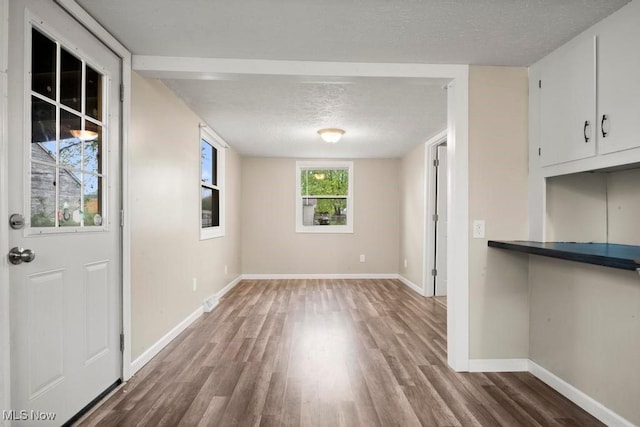 5331 Ridgewood St, Lorain, OH 44055 - unfurnished dining area featuring a textured ceiling, wood finished floors, and baseboards
