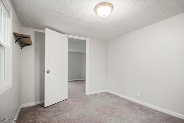 5331 Ridgewood St, Lorain, OH 44055 - unfurnished bedroom with a textured ceiling, carpet floors, and baseboards