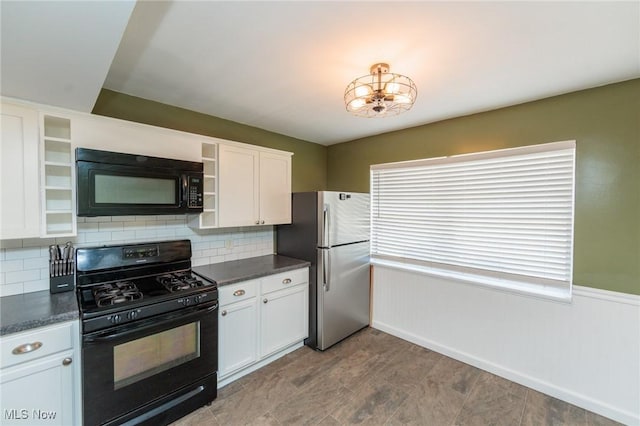 3019 Clague Rd, North Olmsted, OH 44070 - kitchen with black appliances, dark countertops, open shelves, and white cabinets