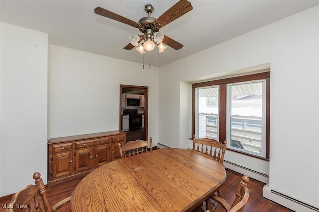 3019 Clague Rd, North Olmsted, OH 44070 - dining area with a ceiling fan, baseboard heating, and wood finished floors