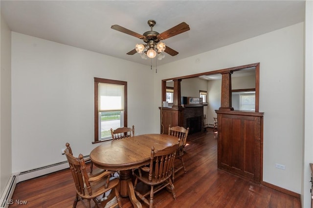 3019 Clague Rd, North Olmsted, OH 44070 - dining space with a fireplace, baseboards, baseboard heating, ceiling fan, and dark wood-style floors