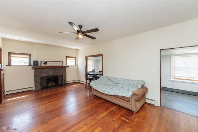 3019 Clague Rd, North Olmsted, OH 44070 - living area with a fireplace, ceiling fan, a baseboard radiator, and wood finished floors