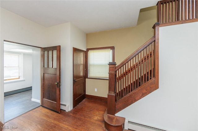 3019 Clague Rd, North Olmsted, OH 44070 - stairway featuring a baseboard radiator, wood-type flooring, and baseboards