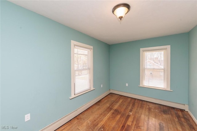 3019 Clague Rd, North Olmsted, OH 44070 - empty room featuring hardwood / wood-style floors, baseboards, and a baseboard heating unit