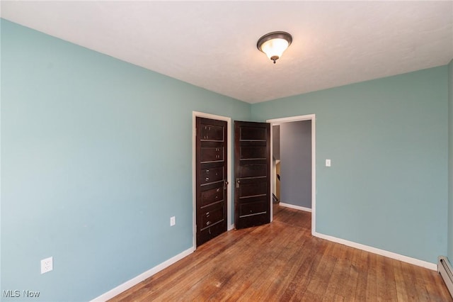 3019 Clague Rd, North Olmsted, OH 44070 - empty room featuring hardwood / wood-style flooring, baseboards, and baseboard heating