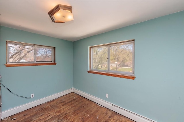 3019 Clague Rd, North Olmsted, OH 44070 - empty room with baseboards, a baseboard radiator, and wood finished floors