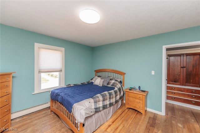 3019 Clague Rd, North Olmsted, OH 44070 - bedroom with a baseboard radiator, baseboards, and wood finished floors