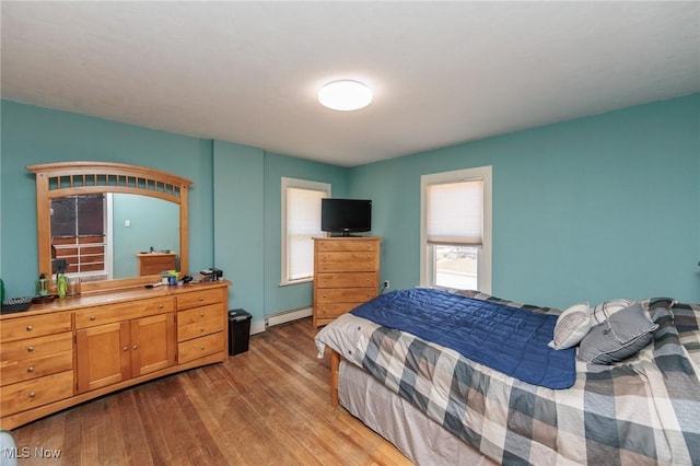 3019 Clague Rd, North Olmsted, OH 44070 - bedroom featuring wood finished floors and a baseboard heating unit