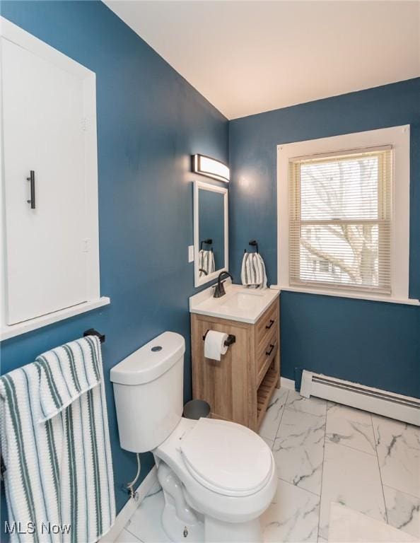 3019 Clague Rd, North Olmsted, OH 44070 - bathroom with lofted ceiling, toilet, marble finish floor, a baseboard heating unit, and vanity