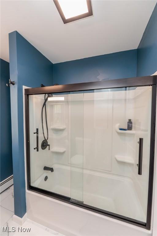 3019 Clague Rd, North Olmsted, OH 44070 - bathroom featuring a baseboard radiator, baseboards, and bath / shower combo with glass door