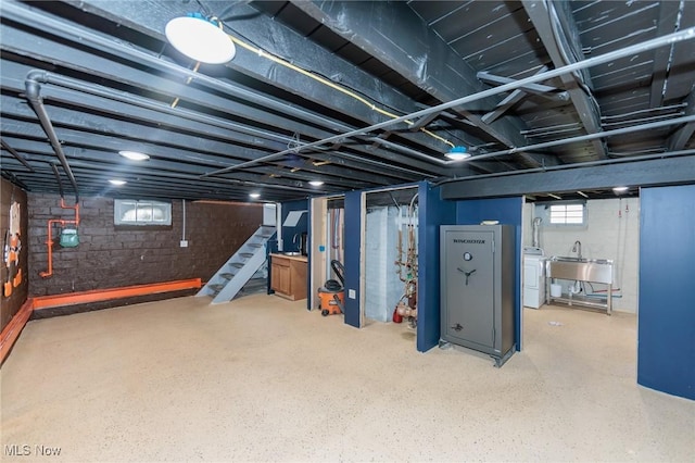 3019 Clague Rd, North Olmsted, OH 44070 - below grade area with washer / dryer, stairway, and a sink