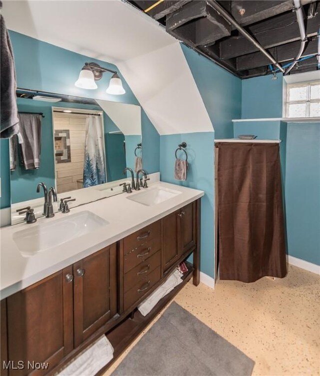 3019 Clague Rd, North Olmsted, OH 44070 - full bath with double vanity, baseboards, and a sink