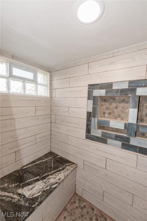 3019 Clague Rd, North Olmsted, OH 44070 - full bathroom featuring wood walls and tiled shower