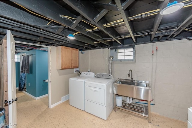 3019 Clague Rd, North Olmsted, OH 44070 - laundry room featuring cabinet space, washing machine and clothes dryer, concrete block wall, and a sink