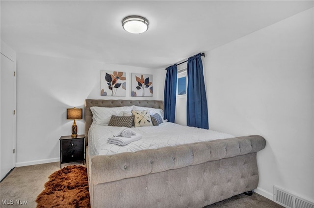 carpeted bedroom with baseboards and visible vents