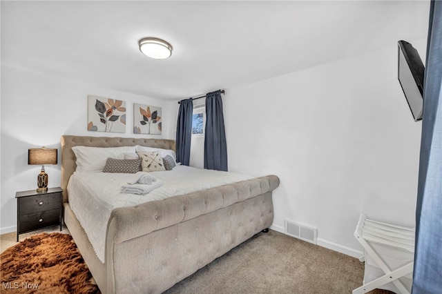 carpeted bedroom featuring baseboards and visible vents