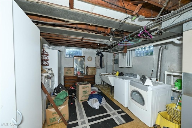 basement featuring independent washer and dryer and a sink
