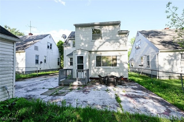 rear view of house featuring fence and a patio area