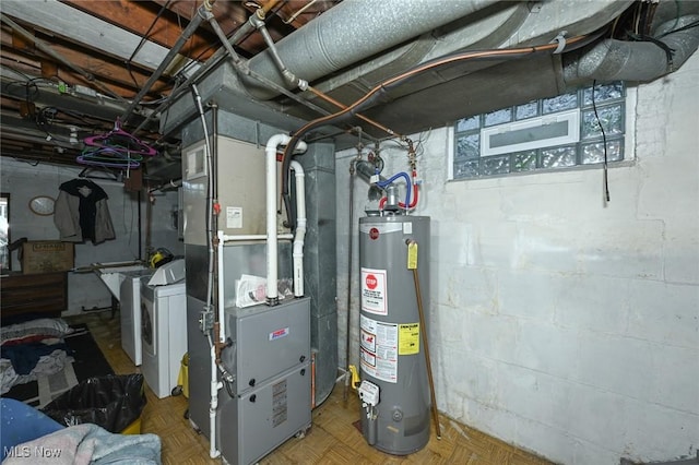 utilities with separate washer and dryer, heating unit, and gas water heater