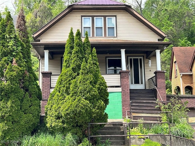 bungalow with covered porch and stairs