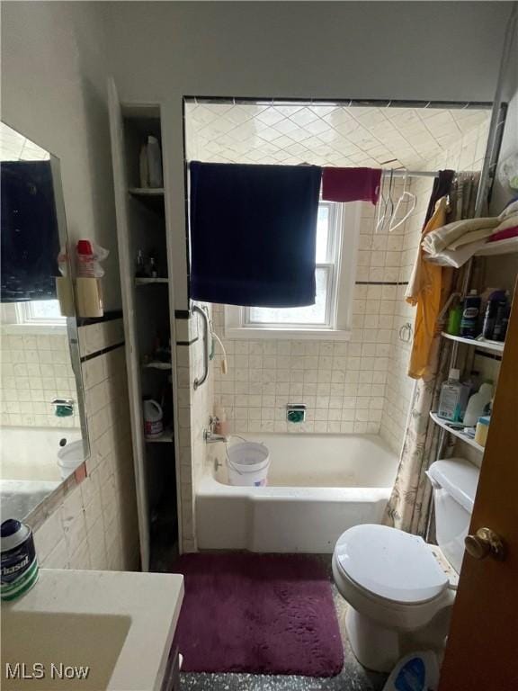 bathroom featuring toilet, a healthy amount of sunlight, a bath, and curtained shower