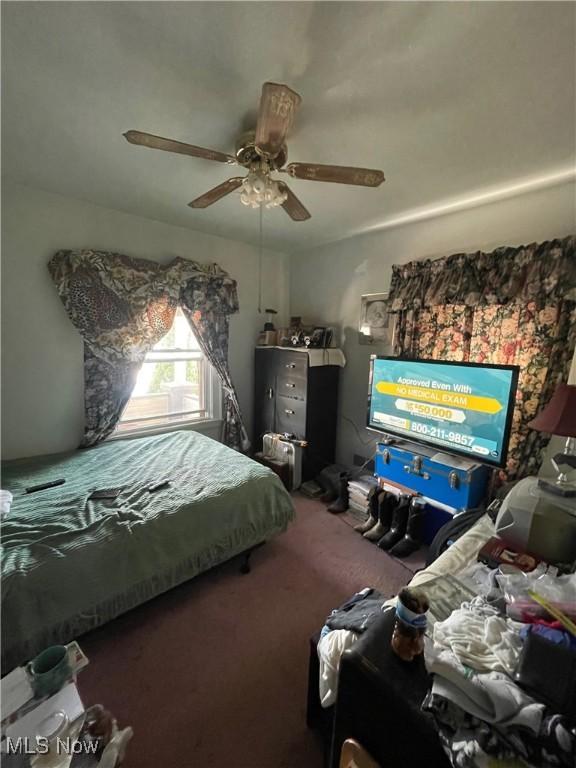carpeted bedroom featuring ceiling fan