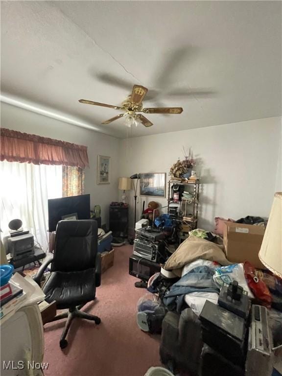 carpeted home office featuring ceiling fan
