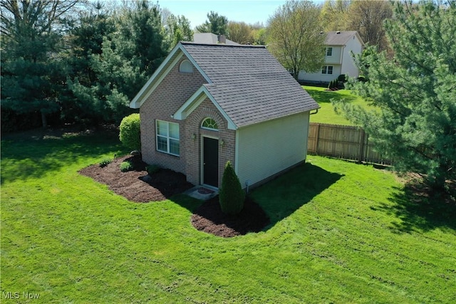 7966 Meadowbrooke Trl, Poland, OH 44514 - view of side of property featuring a yard, brick siding, and fence
