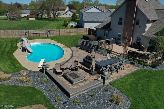 7966 Meadowbrooke Trl, Poland, OH 44514 - view of pool with a water slide, a wooden deck, a patio, and an outdoor living space with a fire pit