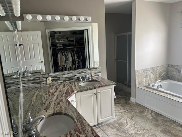 7966 Meadowbrooke Trl, Poland, OH 44514 - bathroom featuring a walk in closet, a bath, a shower stall, backsplash, and vanity