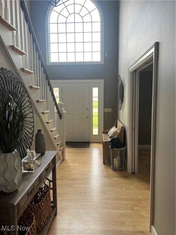 7966 Meadowbrooke Trl, Poland, OH 44514 - foyer entrance with stairway, light wood finished floors, and a towering ceiling
