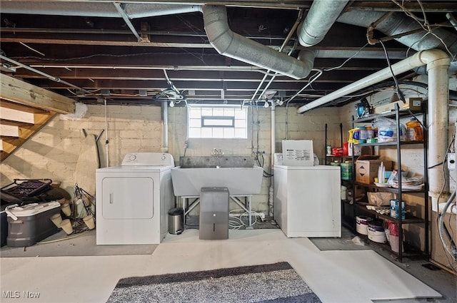 below grade area with a sink and independent washer and dryer