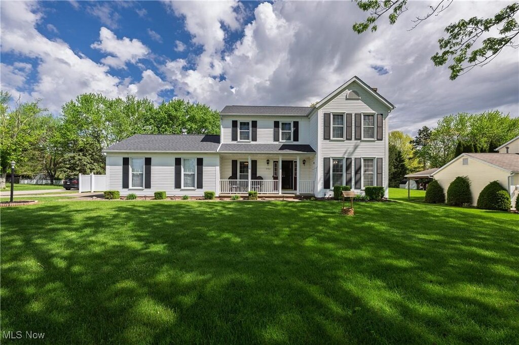3783 Wickham St NW, Uniontown, OH 44685 - traditional-style house featuring a front yard and covered porch