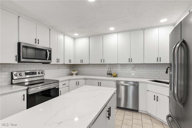 10836 Watercress Rd, Strongsville, OH 44149 - kitchen with recessed lighting, stainless steel appliances, decorative backsplash, and a sink