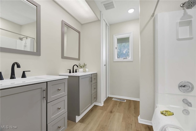 10836 Watercress Rd, Strongsville, OH 44149 - full bathroom featuring a sink, baseboards, visible vents, and wood finished floors