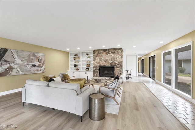 10836 Watercress Rd, Strongsville, OH 44149 - living area with baseboards, a fireplace, light wood-style flooring, and recessed lighting
