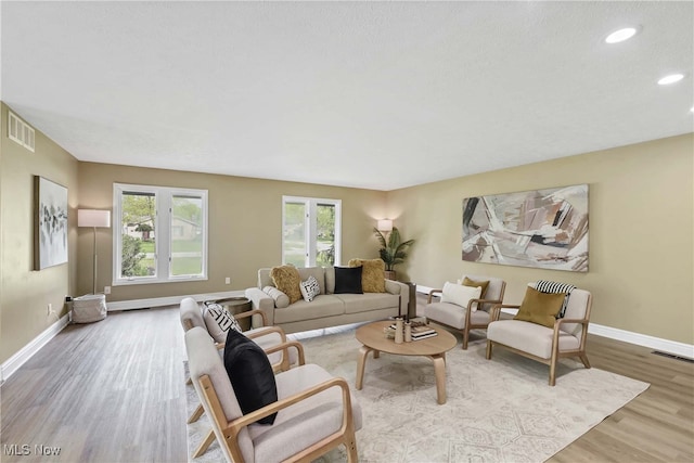 10836 Watercress Rd, Strongsville, OH 44149 - living room featuring visible vents, wood finished floors, baseboards, and recessed lighting
