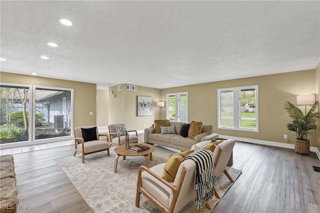 10836 Watercress Rd, Strongsville, OH 44149 - living area featuring wood finished floors, a textured ceiling, visible vents, recessed lighting, and baseboards