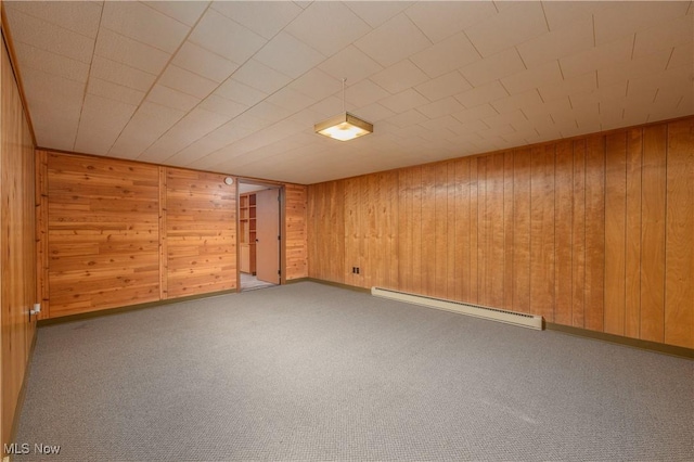 1181 S Broadway, New Philadelphia, OH 44663 - carpeted spare room with wood walls and a baseboard heating unit