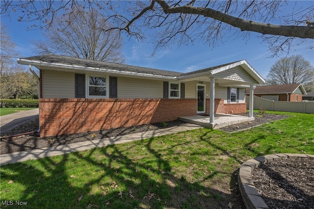 1181 S Broadway, New Philadelphia, OH 44663 - ranch-style home with fence, a front lawn, and brick siding