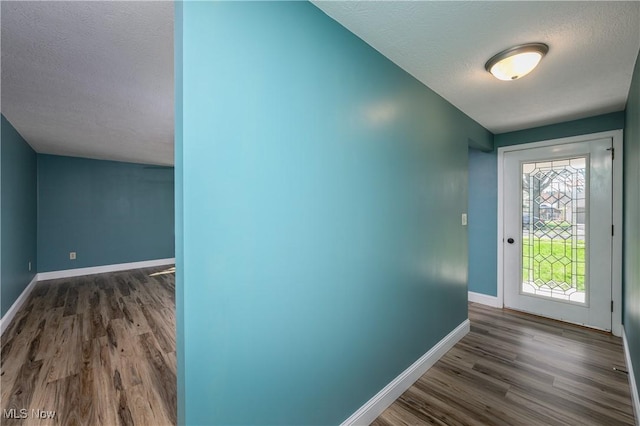 1181 S Broadway, New Philadelphia, OH 44663 - doorway with a textured ceiling, baseboards, and wood finished floors