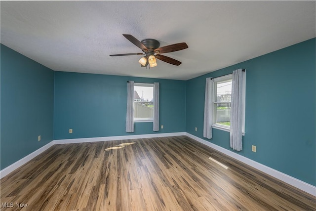 1181 S Broadway, New Philadelphia, OH 44663 - unfurnished room featuring wood finished floors, baseboards, ceiling fan, and a textured ceiling