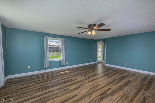 1181 S Broadway, New Philadelphia, OH 44663 - empty room with ceiling fan, baseboards, dark wood-type flooring, and plenty of natural light