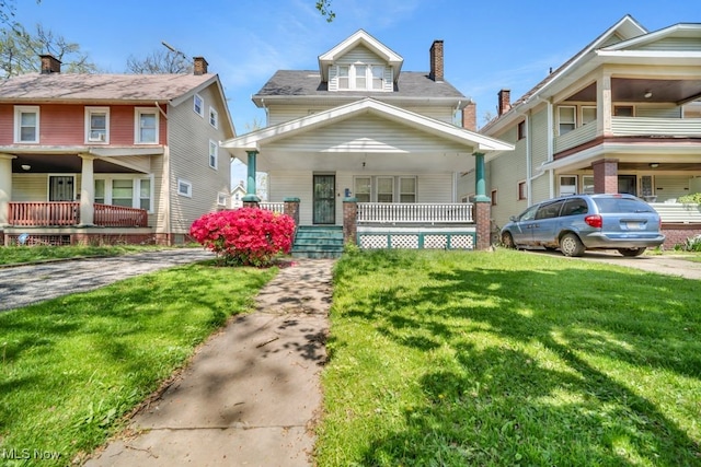 13613 Claiborne Rd, East Cleveland, OH 44112 - traditional style home with a front lawn, a porch, and a chimney